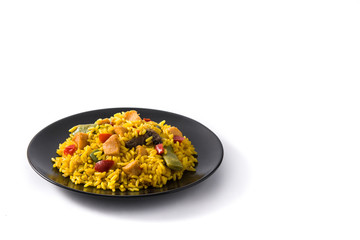 Fried rice with chicken and vegetables on black plate isolated on white background. Copy space
