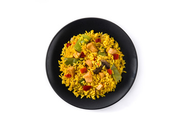 Fried rice with chicken and vegetables on black plate isolated on white background. Top view