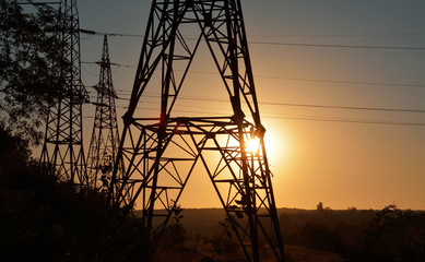 transmission lines tower in sunset