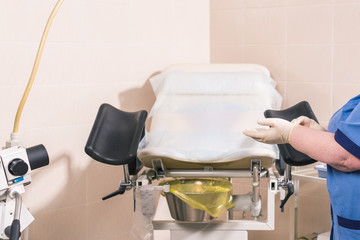 Close-up of doctor hand holds gynecological examination instruments. Gynecologist working in the obstetrics and gynecology department. Medical concept.