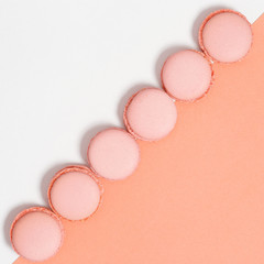 Tasty orange macaroons. Minimal style image with row of almond cookies. Food background, flat lay, copy space.