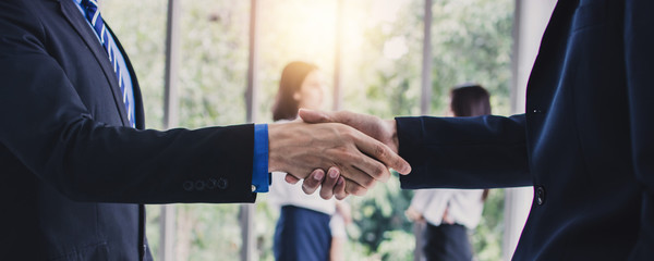 Success business, successful agreement negotiation and confident partner cooperation concept, Businessman shake hands with customer in banner background.