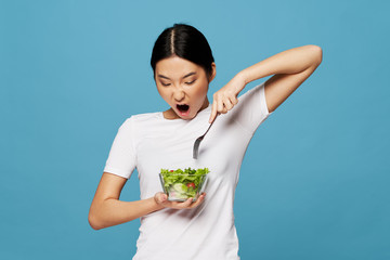 young woman eating salad