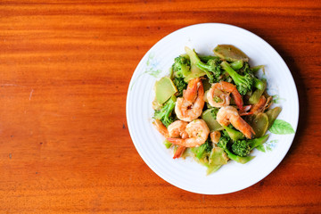 The hot stir fried broccoli with giant shrimp serve on dish - food concept.