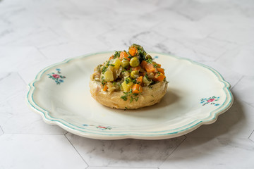 Turkish Artichokes with Olive Oil, Dill and Green Peas Cold Served in Plate.