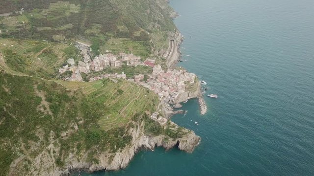 Aerial view of beautiful italian old town om the mountain near the sea in bright sunny summer day at high altitude