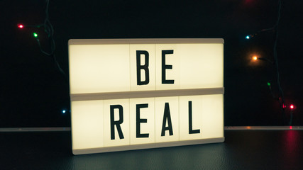 blacklight box isolated with text "be real" 