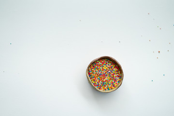 Colourful Sugar sprinkles, decoration for cake, ice-cream and cookies. Top view, Flat lay on white background. Copy space.