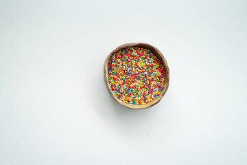 Colourful Sugar sprinkles, decoration for cake, ice-cream and cookies. Top view, Flat lay on white background. Copy space.