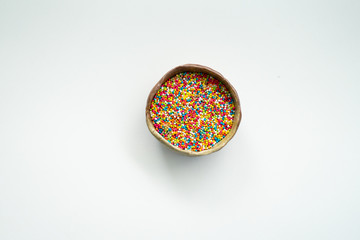 Colourful Sugar sprinkles, decoration for cake, ice-cream and cookies. Top view, Flat lay on white background. Copy space.