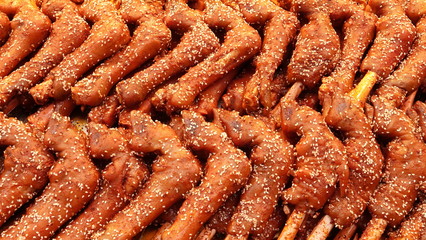 Closeup of Asian street food, braised lamb's foot with white sesame.