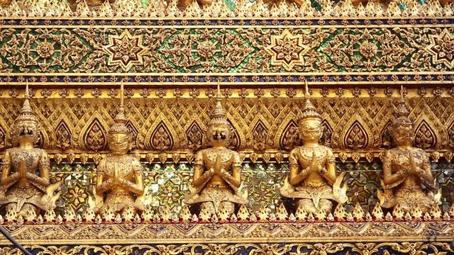 Bangkok Grand Palace - artwork and figurines / statues / buddhas details in gold and showing the beautiful craftsmanship and artistic ability at the Wat Phra Keaw temple complex