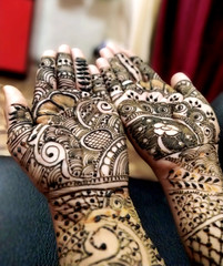 beautifully decorated indian hands with mehandi typically done for weddings