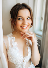 Portrait of cute bride on tulle background