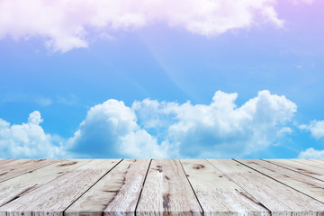 Beautiful empty wood plank table top with white cloud and blue sky background.  for montage of your product