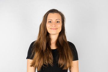 Fototapeta premium Young woman smiling in black shirt with long hair