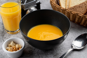 Pumpkin cream soup of pureed pumpkin and crunchy croutons close up