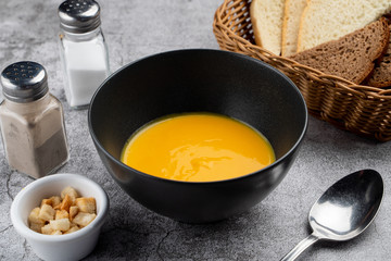 Pumpkin cream soup of pureed pumpkin and crunchy croutons close up