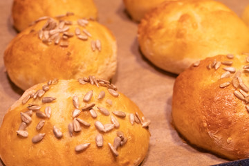 Home made bread rolls or buns for breakfast fresh on a paper on a table, selected focus, narrow depth of field