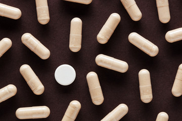 White medical pill stands out among many other capsule pills
