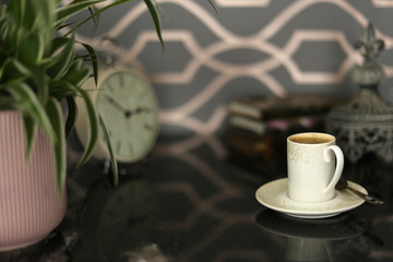 Work space with home plant, books, stationary on black marble desk on modern wall background. Home office, home design concept
