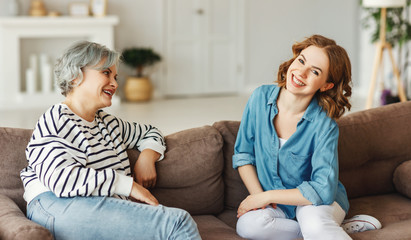 Mother and daughter speaking on couch.