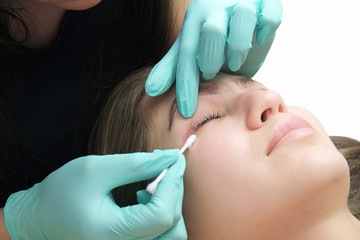 Professional beautician treatment concept. Eyelash lamination, extension performed on beautiful...