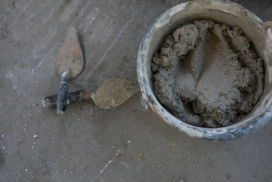 Plastering trowel mixed cement in a bucket