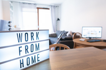 Working from home remote work inspirational social media lightbox message board next to monitor,...