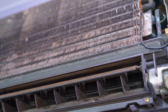 Old Air Conditioner And Focus Evaporator Of Dirty, Foul, Be Putrid Before Cleaning On The Purple Wall In The Home Office In The Summer And Circuit Board Control.