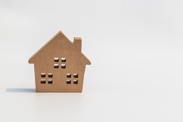 Small wooden toy house on white background.