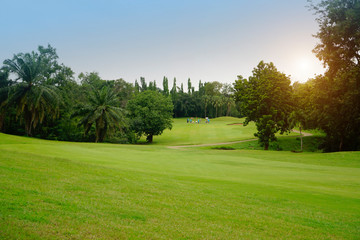 Fototapeta na wymiar Background of evening golf course has sunlight shining down at golf course in Thailand