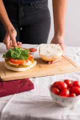 Obraz na płótnie Canvas woman hands preparing homemade burger