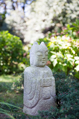 An ornamental stone statue in the garden.
