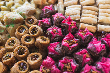 Various types or many colorful assortment of Turkish sweet rolls with nuts and almond.