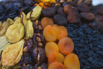 Dried fruits and dried berries on the counter of a small farmers market.