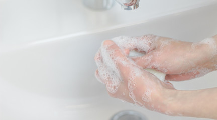 woman washing hands in bathroom