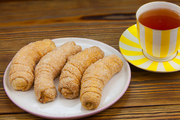 Tasty crispy fresh cookies on a plate on a wooden background