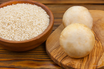 Tasty appetizing risotto on  white plate on  wooden table