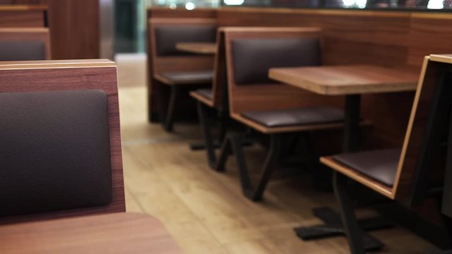 Empty food court interior. Commercial cafe furniture. Wooden tables in a restaurant.