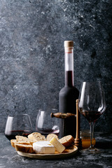 Fototapeta na wymiar Glass of red wine served with cheese