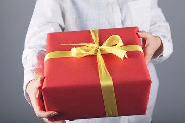 woman hand gift box in face