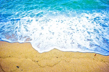 bright blue colored sea waves on the beach