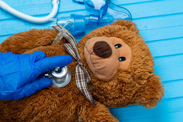 toy bear with inhalation medical mask close up