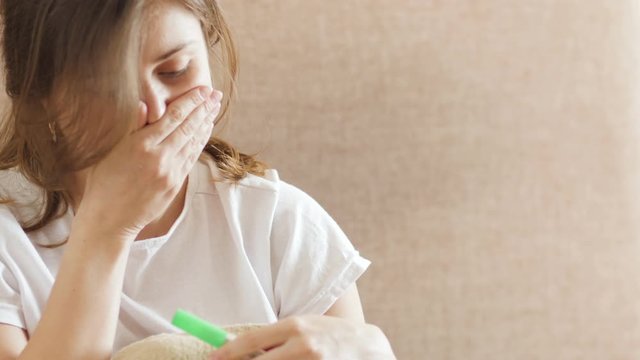 Sick girl lying in bed. Young woman feeling bad in bedroom. Portrait of sick woman sneezing in tissue. Female allergy symptom. Girl feeling bad at evening. Disease woman got flu infection in bedroom