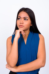 Portrait of young Asian businesswoman thinking and looking up