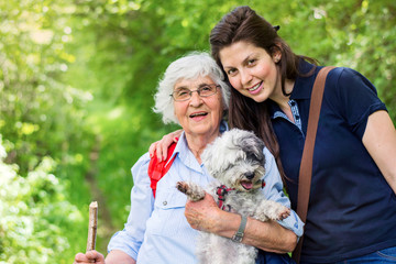 Happy Family with  Dog in the Summer Park .Family Portrait of Grandmother and Granddaughter with Dog