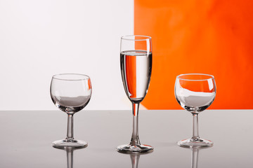 Three glasses of wine against colorful background