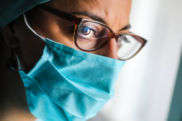 Woman doctor wearing a surgical mask and glasses