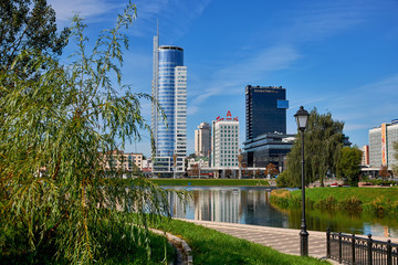 Belarus, Minsk, August 2019. Skyscrapers of the business center on the banks of the Svisloch river. Urban water landscape.